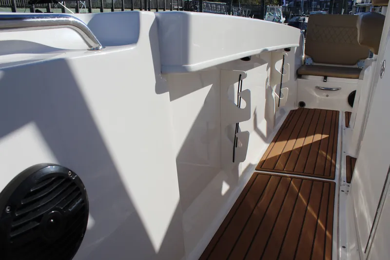 Slide: The Image of 2024 Bayliner CC22 boat interior with teak flooring and seating. - 15