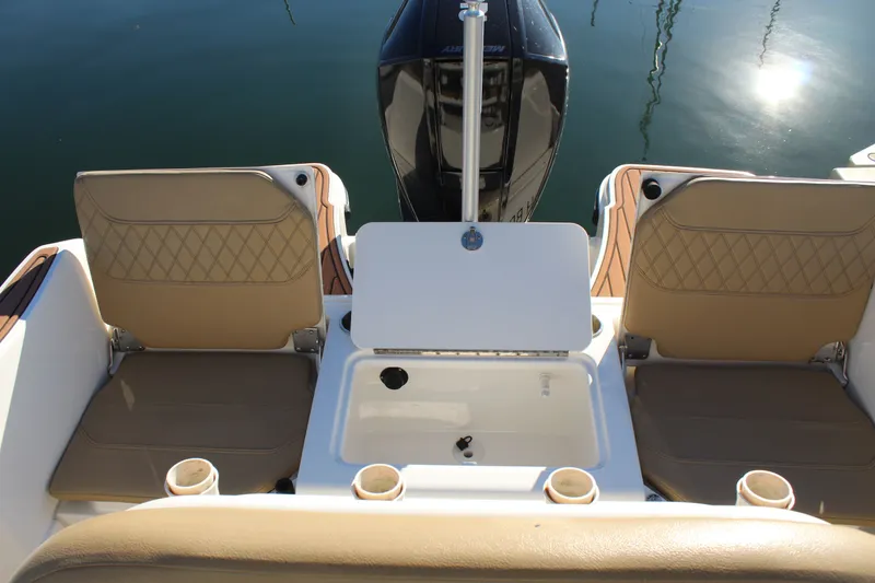 Slide: The Image of 2024 Bayliner CC22 boat interior with seating and storage compartment. - 20