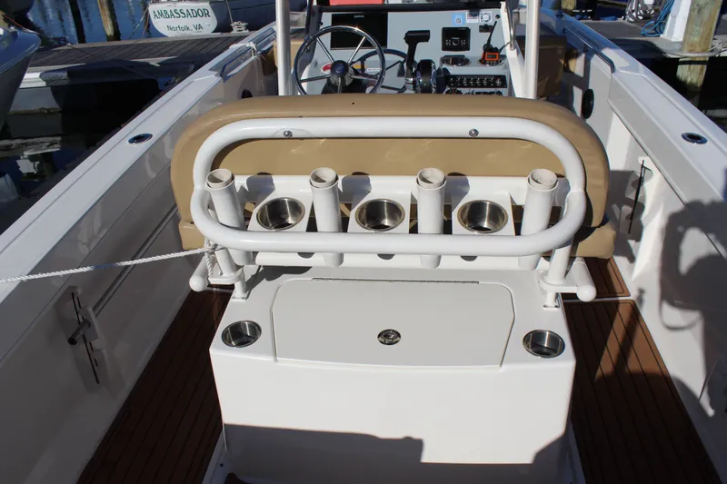Slide: The Image of 2024 Bayliner CC22 boat interior with rod holders and seating, docked in Norfolk, VA. - 21