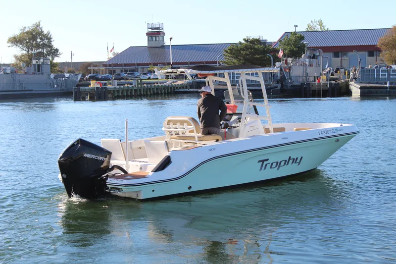 Slide: The Image of 2024 Bayliner CC22 boat on water near dock, featuring Mercury outboard engine. - 4