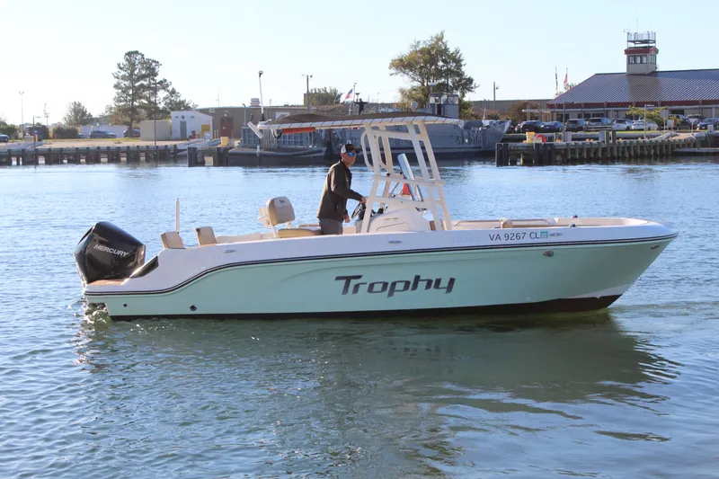 Slide: The Image of 2024 Bayliner CC22 boat on water, featuring Mercury engine, dockside background. - 5