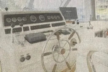 Slide: The Image of 1985 Bertram 58 Flybridge helm with steering wheel and instrument panel. - 5