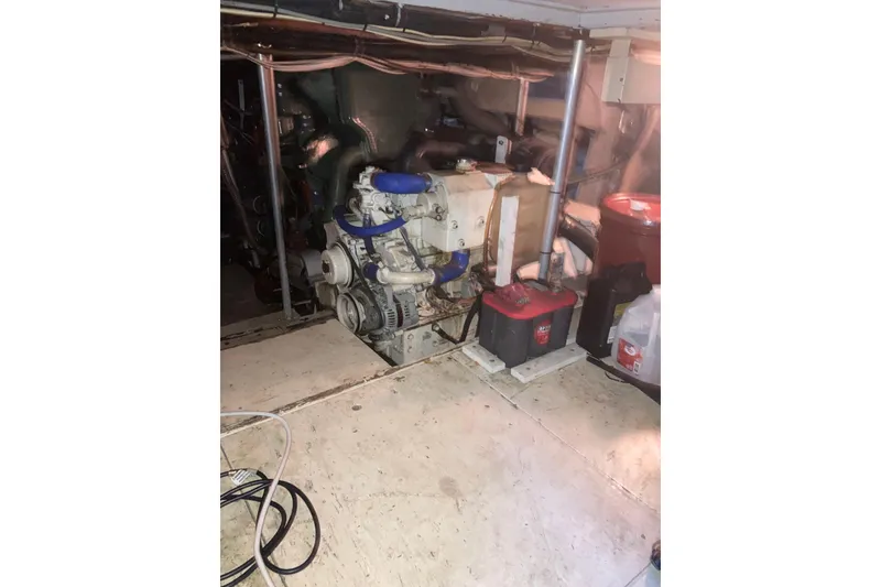 Slide: The Image of Engine room of 1985 Bertram 58 Flybridge with visible machinery and equipment. - 6