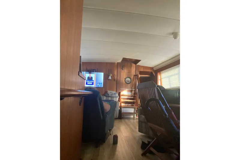 Slide: The Image of Interior of 1985 Bertram 58 Flybridge yacht with wooden decor and seating area. - 7