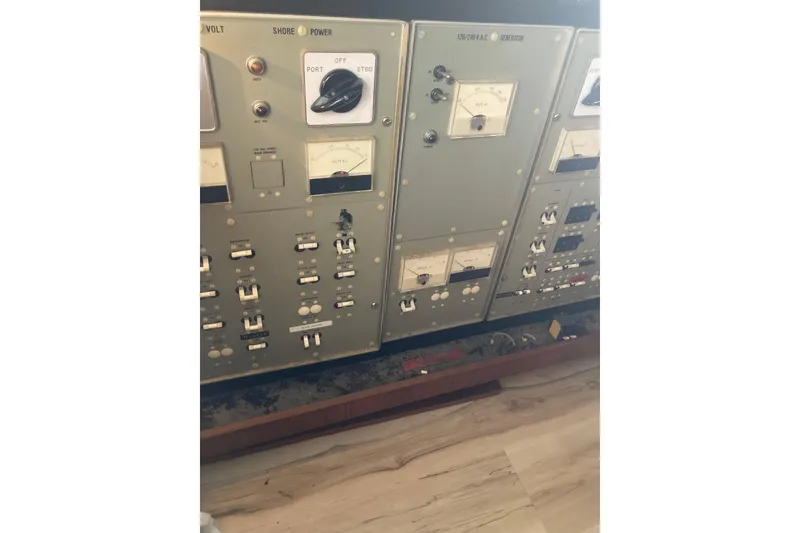 Slide: The Image of Control panel of a 1985 Bertram 58 Flybridge yacht, featuring switches and gauges. - 8