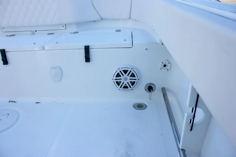 Slide: The Image of Interior of 2026 Sea Hunt Ultra 229 boat, featuring seating and speaker system. - 17