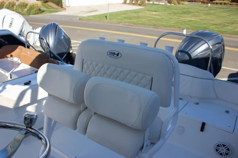 Slide: The Image of 2026 Sea Hunt Ultra 229 boat with dual Yamaha engines and plush seating. - 19