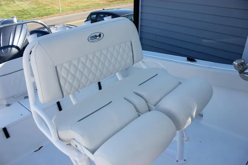 Slide: The Image of 2026 Sea Hunt Ultra 229 boat seat with white cushioned design. - 20