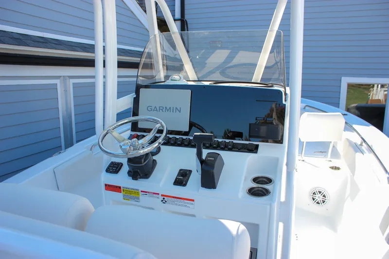 Slide: The Image of 2026 Sea Hunt Ultra 229 boat dashboard with Garmin navigation system and steering wheel. - 23