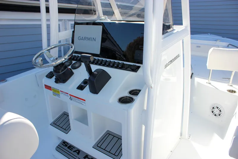 Slide: The Image of 2026 Sea Hunt Ultra 229 boat console with Garmin navigation system and steering wheel. - 26