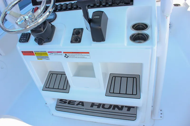 Slide: The Image of 2026 Sea Hunt Ultra 229 boat console with steering wheel and controls. - 27