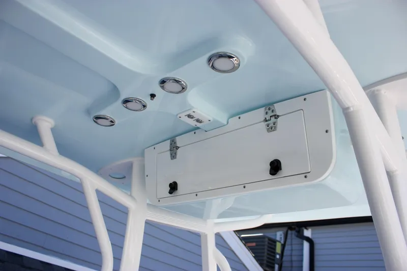 Slide: The Image of 2026 Sea Hunt Ultra 229 boat interior with blue ceiling and storage compartment. - 28