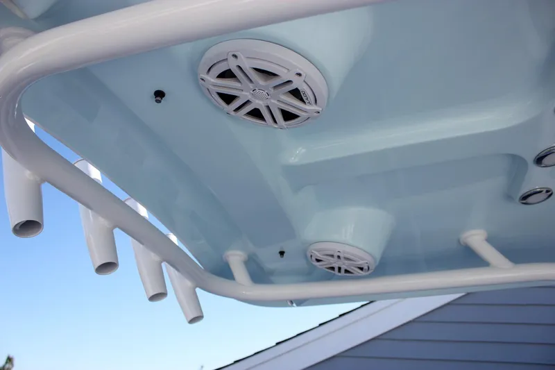 Slide: The Image of 2026 Sea Hunt Ultra 229 boat T-top with speakers and rod holders. - 29