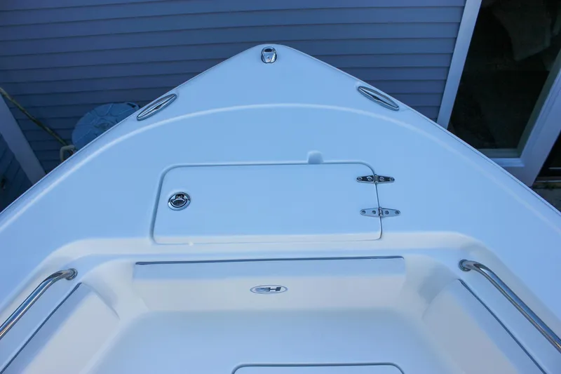Slide: The Image of Bow of 2026 Sea Hunt Ultra 229 boat with storage compartment and stainless steel rails. - 32