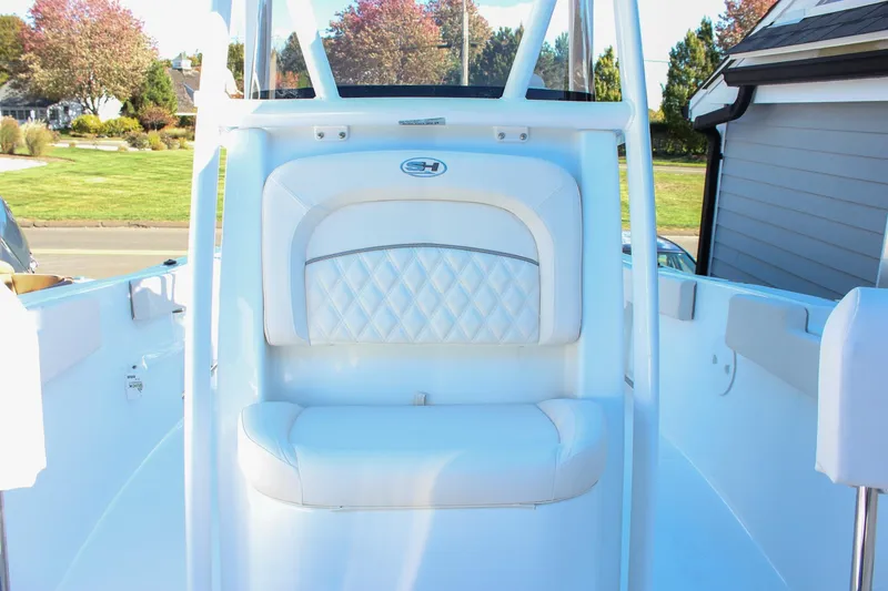 Slide: The Image of 2026 Sea Hunt Ultra 229 boat interior with white cushioned seating. - 34