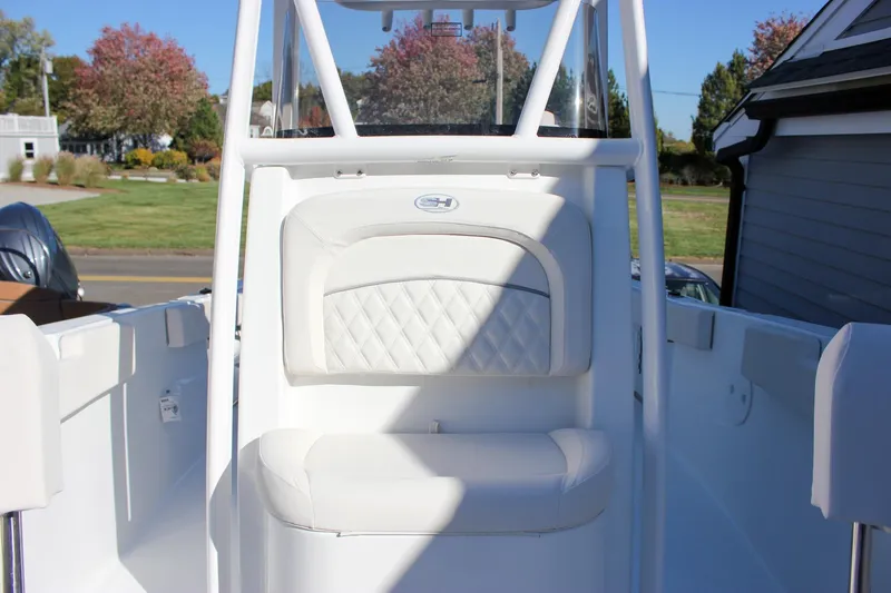 Slide: The Image of 2026 Sea Hunt Ultra 229 boat interior with white cushioned seating. - 36