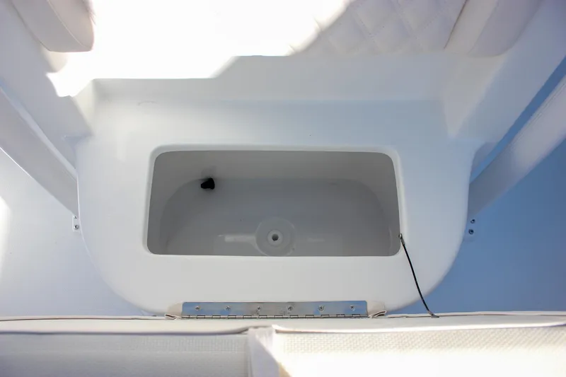 Slide: The Image of Livewell compartment on a 2026 Sea Hunt Ultra 229 boat, featuring a clean, white interior. - 37