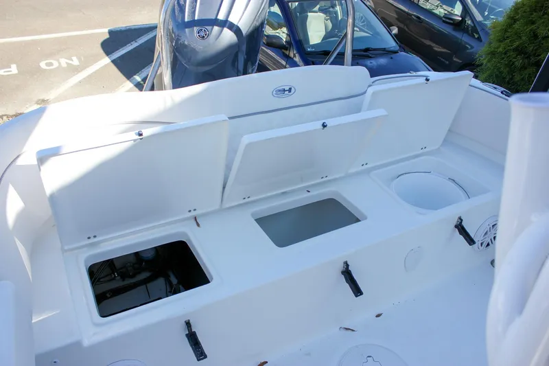 Slide: The Image of 2026 Sea Hunt Ultra 229 boat interior with open storage compartments and seating. - 39