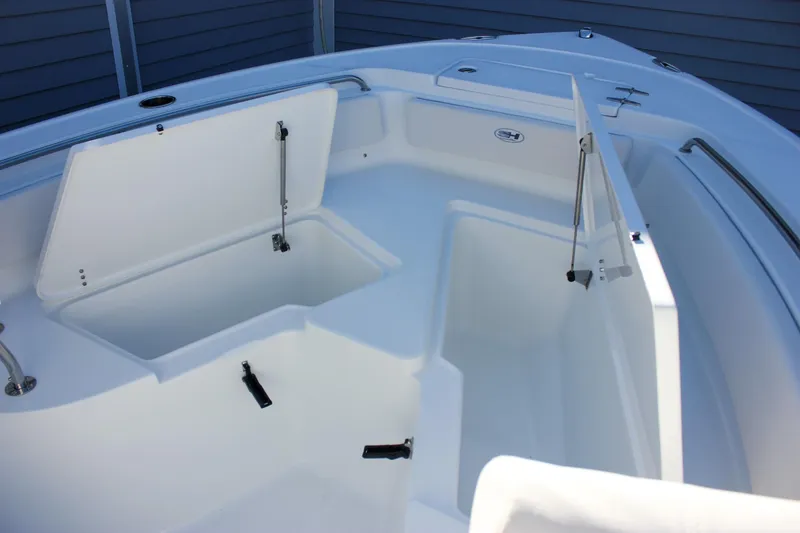 Slide: The Image of 2026 Sea Hunt Ultra 229 boat with open storage compartments, showcasing sleek design and functionality. - 42