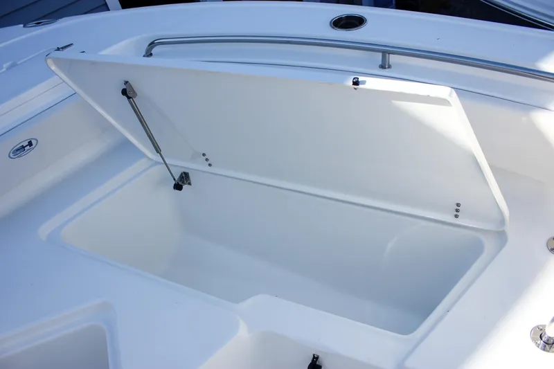 Slide: The Image of Open storage compartment on 2026 Sea Hunt Ultra 229 boat, featuring sleek white design. - 43