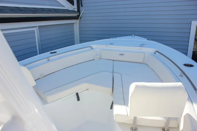 Slide: The Image of 2026 Sea Hunt Ultra 229 boat interior with white cushioned seating. - 46