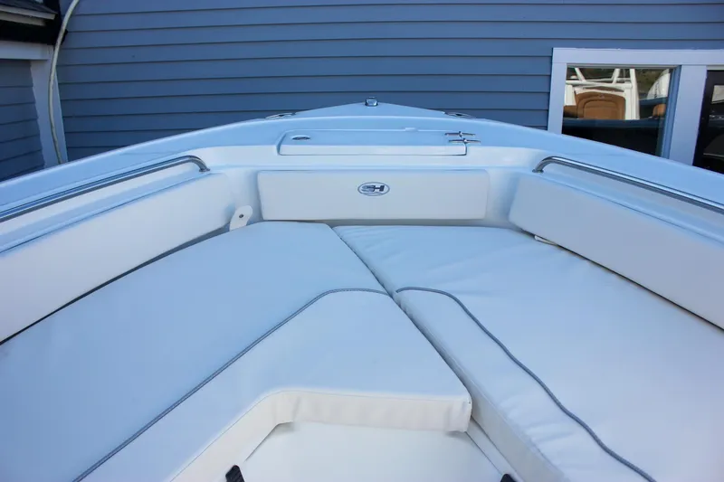 Slide: The Image of 2026 Sea Hunt Ultra 229 boat interior with white cushioned seating. - 47