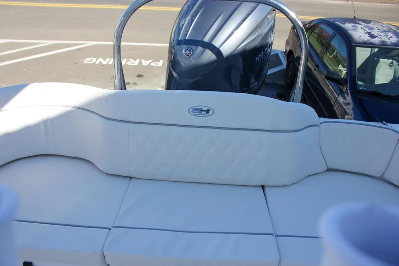 Slide: The Image of 2026 Sea Hunt Ultra 229 boat with white cushioned seating and Yamaha engine. - 49