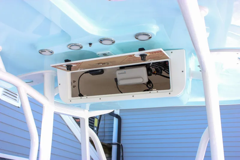 Slide: The Image of 2026 Sea Hunt Ultra 229 boat console with electronic equipment and storage compartment. - 5