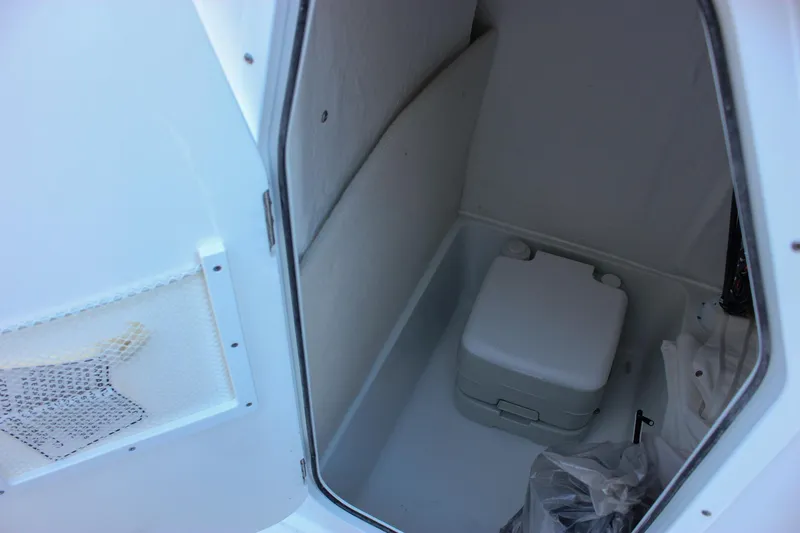 Slide: The Image of Interior of 2026 Sea Hunt Ultra 229 boat with compact portable toilet. - 8