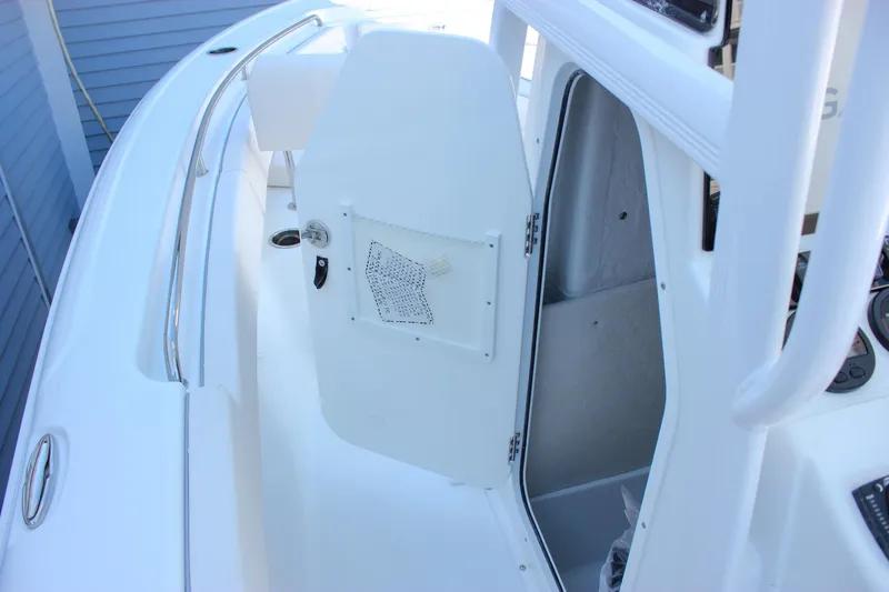 Slide: The Image of 2026 Sea Hunt Ultra 229 boat interior with open storage compartment. - 9