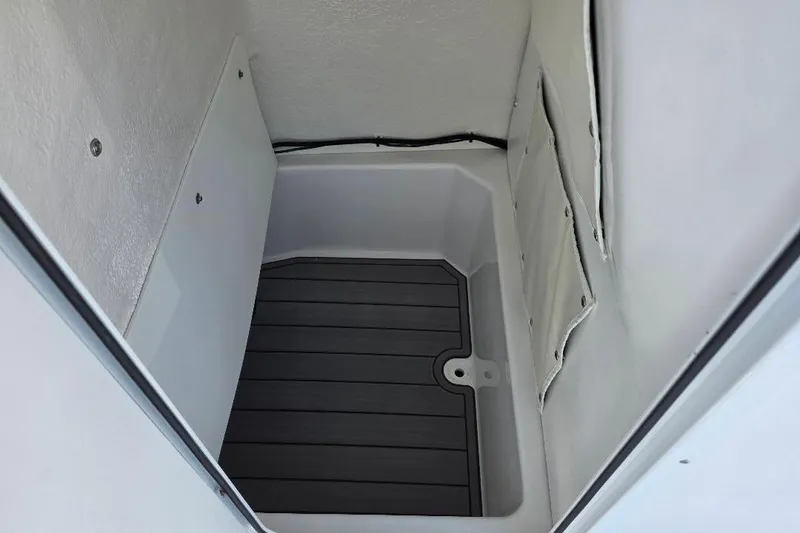 Slide: The Image of Storage compartment of 2026 NauticStar 224 Bay boat, featuring a sleek, durable interior design. - 12