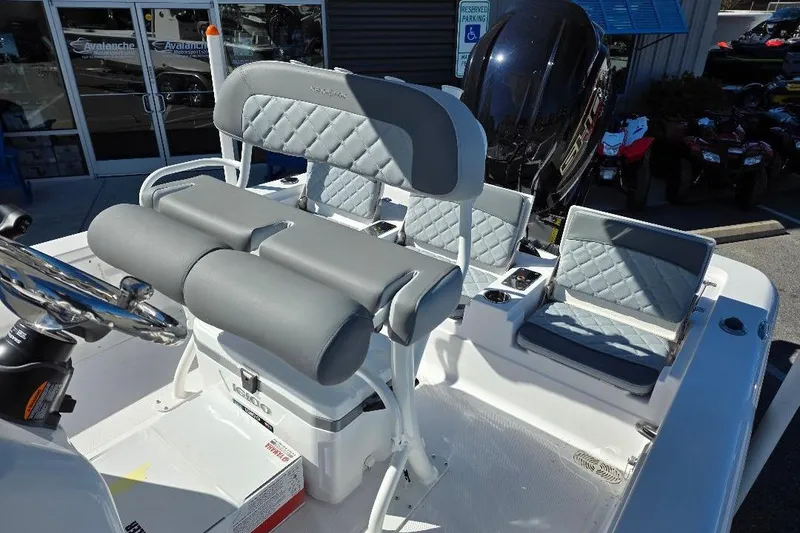 Slide: The Image of 2026 NauticStar 224 Bay boat interior with gray cushioned seating and steering wheel. - 13