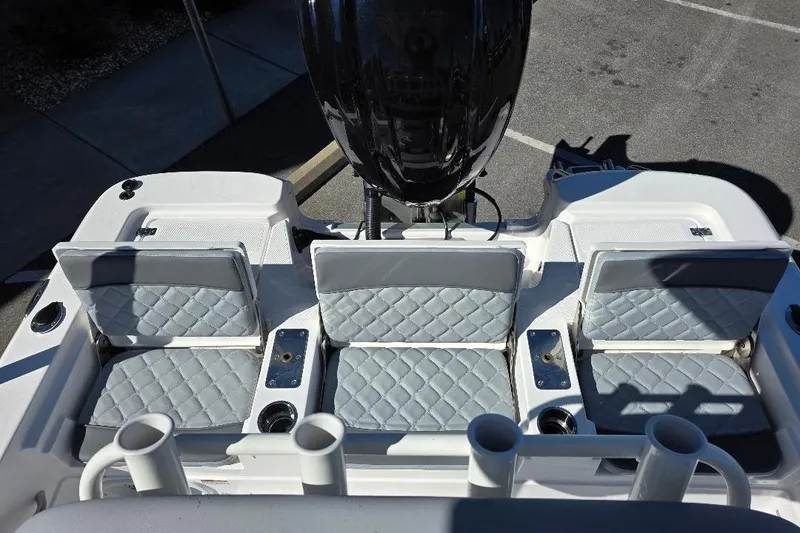 Slide: The Image of 2026 NauticStar 224 Bay boat with quilted seats and rod holders. - 14