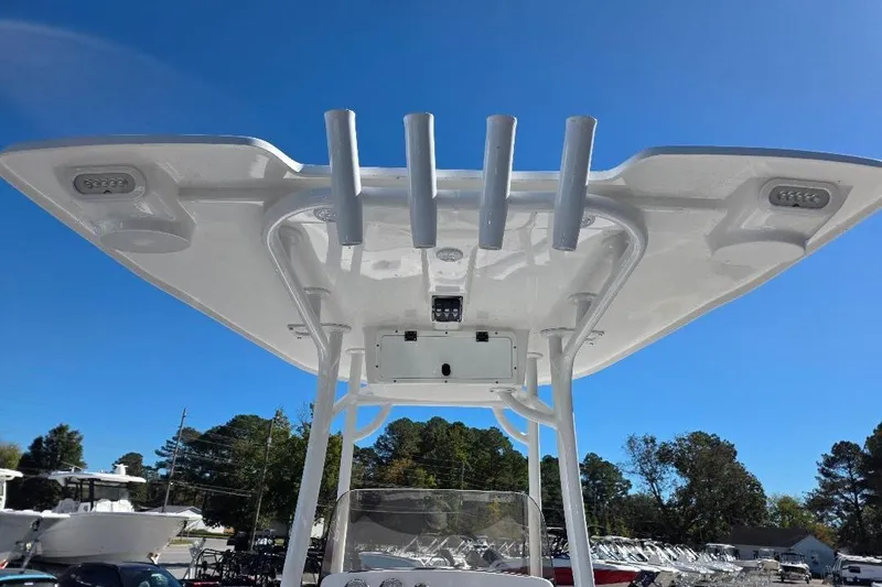 Slide: The Image of T-top of 2026 NauticStar 224 Bay boat under clear blue sky. - 15