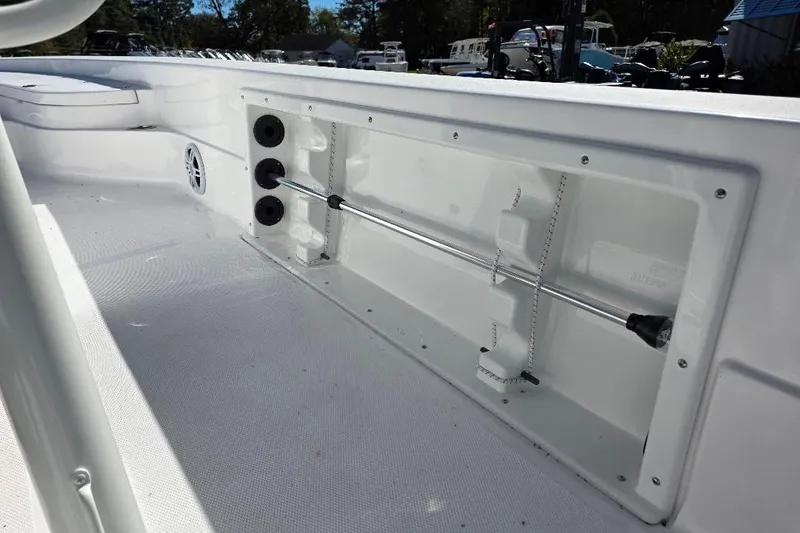 Slide: The Image of 2026 NauticStar 224 Bay boat interior, featuring rod holders and sleek white design. - 17