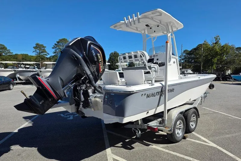 Slide: The Image of 2026 NauticStar 224 Bay boat on trailer, featuring powerful outboard motor. - 5