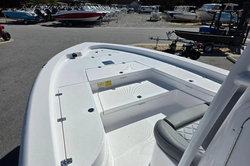 Slide: The Image of 2026 NauticStar 224 Bay boat interior, showcasing spacious deck and seating area. - 9