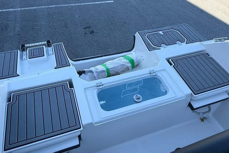 Slide: The Image of 2026 Starcraft SVX 191 OB boat interior with storage compartments and seating. - 12