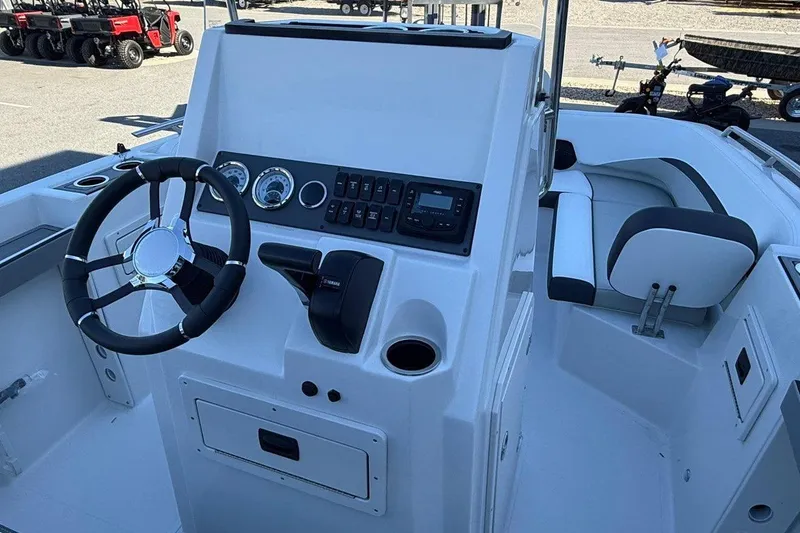 Slide: The Image of 2026 Starcraft SVX 191 OB boat interior with steering wheel and control panel. - 14