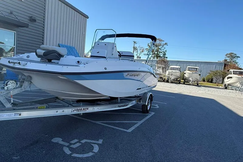 Slide: The Image of 2026 Starcraft SVX 191 OB boat on trailer in parking lot, clear sky background. - 6