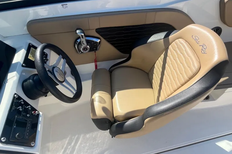 Slide: The Image of 2023 Sea Ray SPX 230 Outboard helm with tan and black captain's seat. - 10