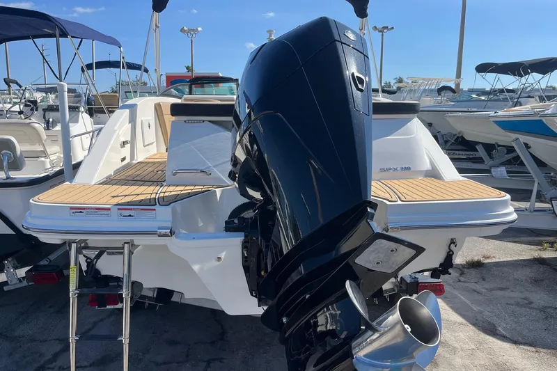 Slide: The Image of 2023 Sea Ray SPX 230 Outboard boat with powerful engine, docked in marina. - 13