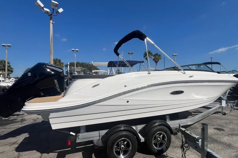 Slide: The Image of 2023 Sea Ray SPX 230 Outboard boat on trailer under clear blue sky. - 3