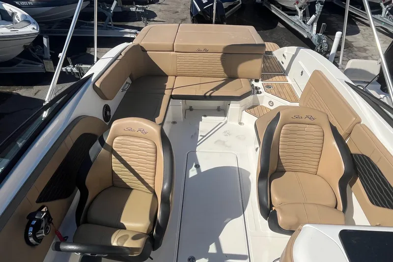Slide: The Image of 2023 Sea Ray SPX 230 Outboard boat interior with tan leather seating and modern design. - 6