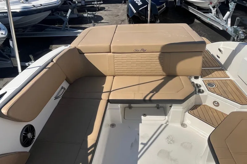 Slide: The Image of 2023 Sea Ray SPX 230 Outboard boat interior with tan seating and modern design. - 8