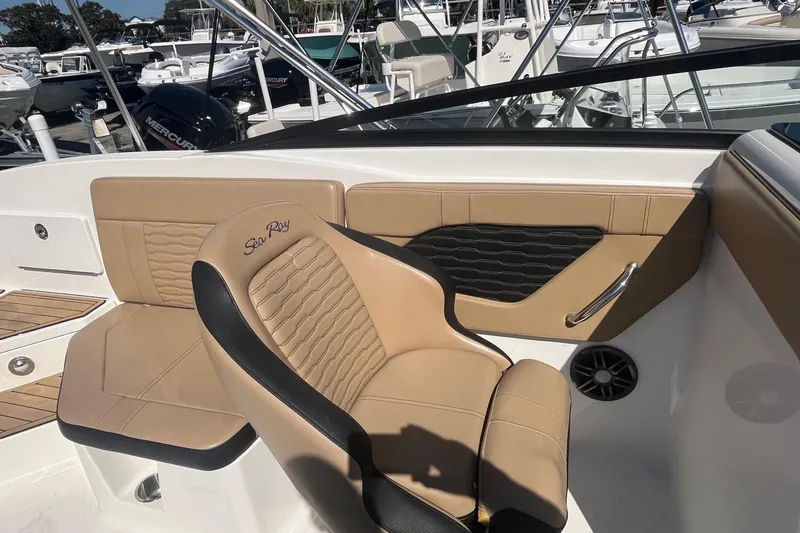 Slide: The Image of 2023 Sea Ray SPX 230 Outboard boat interior with tan leather seating and modern design. - 9