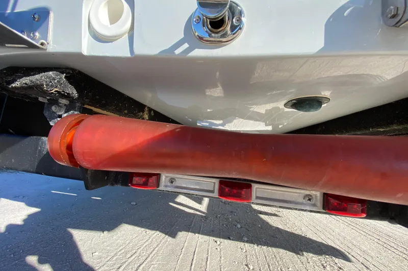 Slide: The Image of 2024 Drake Boatworks Nomad rear view with red pipe and trailer lights. - 13