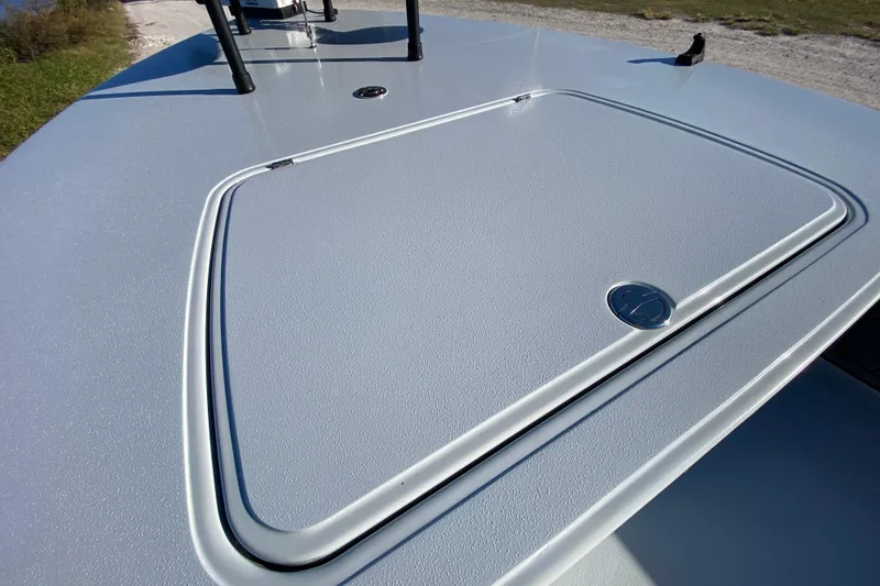Slide: The Image of 2024 Drake Boatworks Nomad deck with storage hatch, showcasing sleek design and functionality. - 20