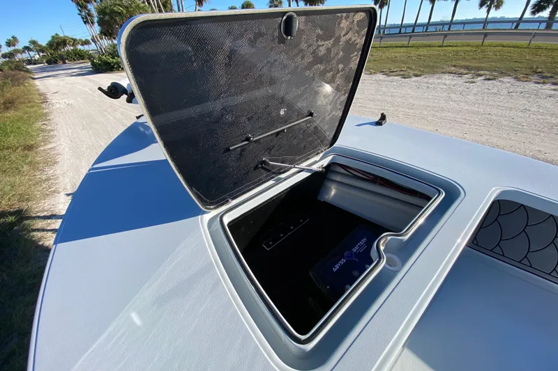 Slide: The Image of 2024 Drake Boatworks Nomad storage compartment with open hatch, showcasing interior details. - 21