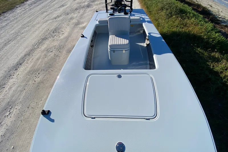 Slide: The Image of 2024 Drake Boatworks Nomad on a dirt path, showcasing sleek design and seating. - 28